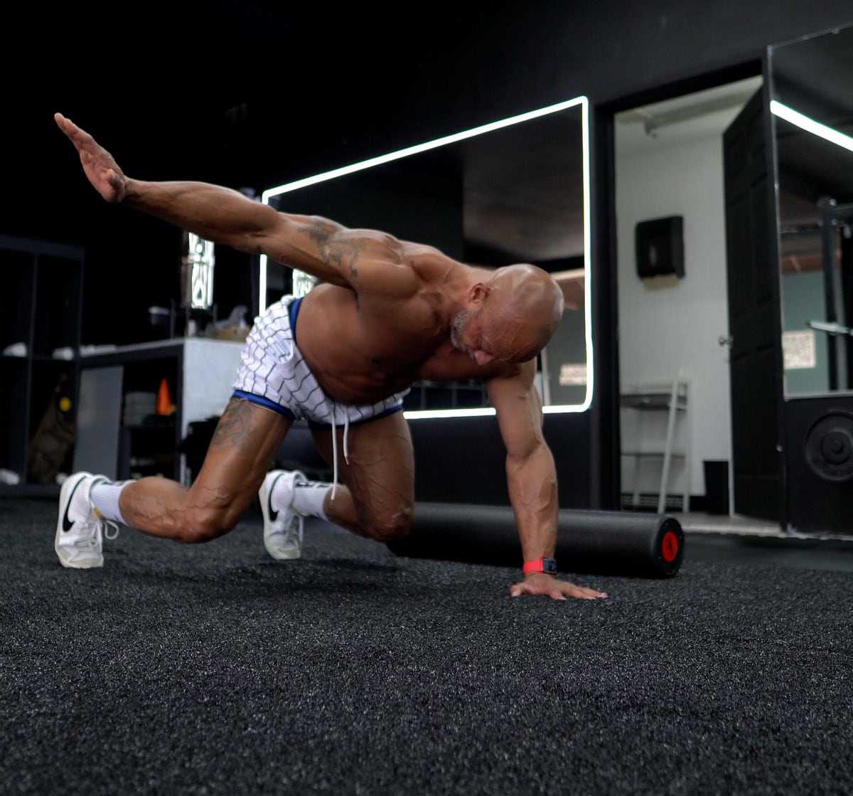 Coach is working out in the gym, on the ground.